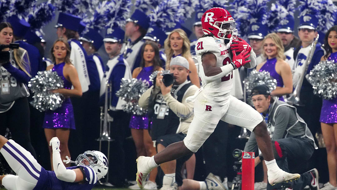 Rutgers running back Antwan Raymond (21) breaks a tackle on Kansas State cornerback Keenan Garber (1) on his way to a touchdown during first half of the Rate Bowl at Chase Field on Dec. 26, 2024, in Phoenix.