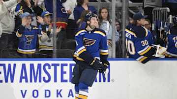 Apr 15, 2025; St. Louis, Missouri, USA; St. Louis Blues right wing Jimmy Snuggerud (21) reacts after scoring his first NHL goal against the Utah Hockey Club during the first period at Enterprise Center. Mandatory Credit: Jeff Le-Imagn Images