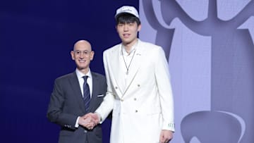 Yang Hansen stands with NBA commissioner Adam Silver after being selected as the 16th pick by the Memphis Grizzlies.