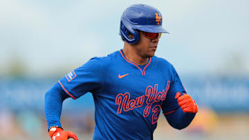 Feb 24, 2025; Jupiter, Florida, USA; New York Mets right fielder Juan Soto (22) hits a single against the St. Louis Cardinals during the third inning at Roger Dean Chevrolet Stadium. Mandatory Credit: Sam Navarro-Imagn Images