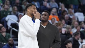 Milwaukee Bucks forward Giannis Antetokounmpo and his brother, Milwaukee Bucks forward Thanasis Antetokounmpo, talk during a timeout against the Detroit Pistons in the second half at Fiserv Forum on April 13.