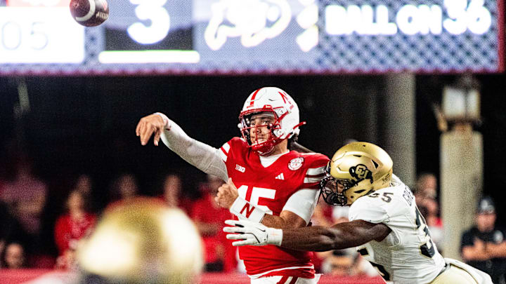 Sep 7, 2024; Lincoln, Nebraska, USA; Nebraska Cornhuskers quarterback Dylan Raiola (15) throws as he’s hit by Colorado Buffaloes defensive end BJ Green II (35) during the third quarter at Memorial Stadium. Mandatory Credit: Dylan Widger-Imagn Images