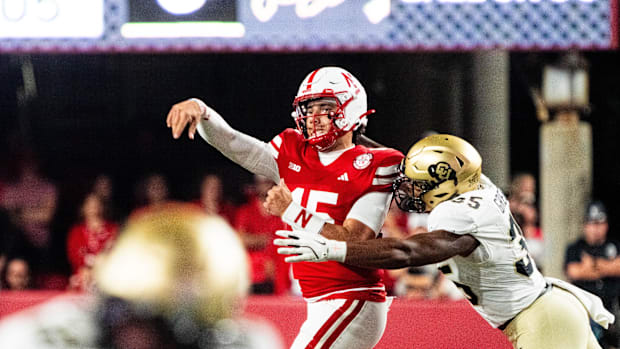 Nebraska Cornhuskers quarterback Dylan Raiola (15) throws as he’s hit by Colorado Buffaloes defensive end BJ Green II