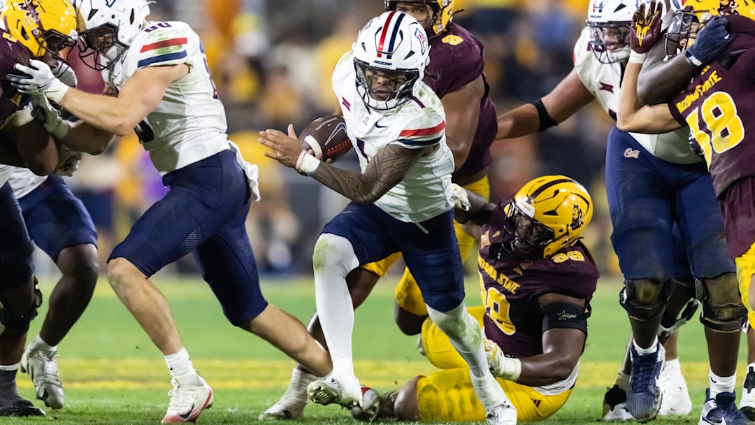 Nov 28, 2025; Tempe, Arizona, USA; Arizona Wildcats quarterback Noah Fifita (1) runs the ball against the Arizona State Sun Devils in the second half during the 99th Territorial Cup at Mountain America Stadium. Mandatory Credit: Mark J. Rebilas-Imagn Images