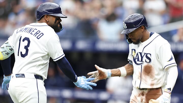 Apr 6, 2026; St. Petersburg, Florida, USA; Tampa Bay Rays center fielder Chandler Simpson (14) greets third baseman Junior Caminero (13) after hitting a home run against the Chicago Cubs in the third inning at Tropicana Field. Mandatory Credit: Nathan Ray Seebeck-Imagn Images