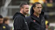 Oct 25, 2025; Eugene, Oregon, USA; Oregon Ducks head coach Dan Lanning, left, and Wisconsin Badgers head coach Luke Fickell talk while watching players warm up before a game at Autzen Stadium. Mandatory Credit: Troy Wayrynen-Imagn Images