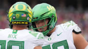 Sep 30, 2023; Stanford, California, USA; Oregon Ducks offensive lineman Jackson Powers-Johnson (right) talks with quarterback Bo Nix (left) during the first quarter against the Stanford Cardinal at Stanford Stadium.