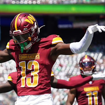 Aug 10, 2024; East Rutherford, New Jersey, USA; Washington Commanders cornerback Emmanuel Forbes (13) celebrates after breaking up a pass to New York Jets wide receiver Mike Williams (18) during the first quarter at MetLife Stadium. Mandatory Credit: Lucas Boland-Imagn Images