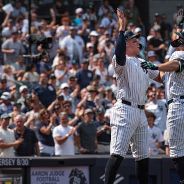 Aug 11, 2024; Bronx, New York, USA; New York Yankees designated hitter Giancarlo Stanton (27) celebrates after hitting a three run home run with center fielder Aaron Judge (99) during the fifth inning against the Texas Rangers at Yankee Stadium. Mandatory Credit: Vincent Carchietta-USA TODAY Sports