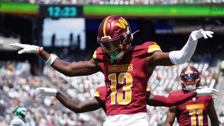 Aug 10, 2024; East Rutherford, New Jersey, USA; Washington Commanders cornerback Emmanuel Forbes (13) celebrates after breaking up a pass to New York Jets wide receiver Mike Williams (18) during the first quarter at MetLife Stadium. Mandatory Credit: Lucas Boland-USA TODAY Sports