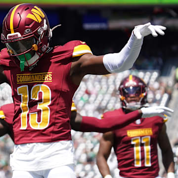 Aug 10, 2024; East Rutherford, New Jersey, USA; Washington Commanders cornerback Emmanuel Forbes (13) celebrates after breaking up a pass to New York Jets wide receiver Mike Williams (18) during the first quarter at MetLife Stadium.