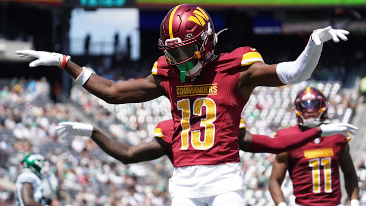 Aug 10, 2024; East Rutherford, New Jersey, USA; Washington Commanders cornerback Emmanuel Forbes (13) celebrates after breaking up a pass to New York Jets wide receiver Mike Williams (18) during the first quarter at MetLife Stadium.