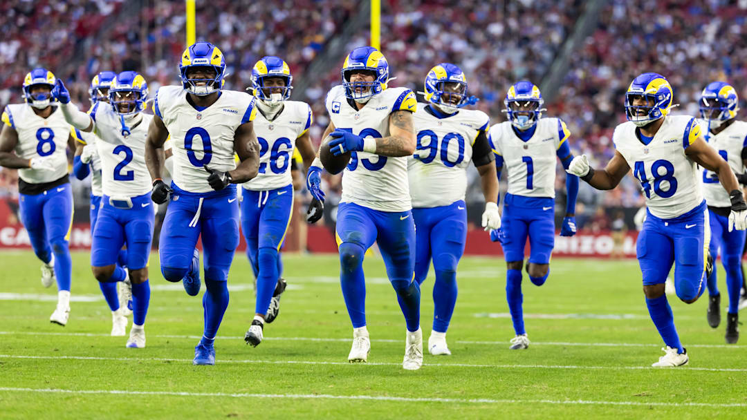 Dec 7, 2025; Glendale, Arizona, USA; Los Angeles Rams  linebacker Nate Landman (53) celebrates an interception with Jaylen McCollough (2), Byron Young (0), Kamren Kinchens (26), Tyler Davis (90), Emmanuel Forbes Jr. (1) and Omar Speights (48) against the Arizona Cardinals at State Farm Stadium. Mandatory Credit: Mark J. Rebilas-Imagn Images