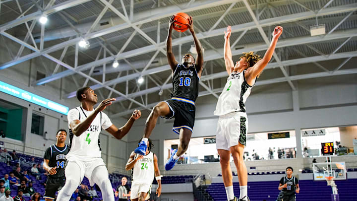 Gibbs Gladiators guard Jacob Daniels (10) goes for a lay up as St. Joseph Knights guard Malcolm Price (2) guards him during the second quarter of the City of Palms Classic sunshine series championship game at Suncoast Credit Union Arena in Fort Myers, Fla., on Saturday, Dec. 21, 2024. Gibbs Gladiators guard Jacob Daniels (10) goes for a lay up as St. Joseph Knights guard Malcolm Price (2) guards him during the second quarter of the City of Palms Classic sunshine series championship game at Suncoast Credit Union Arena in Fort Myers, Fla., on Saturday, Dec. 21, 2024.