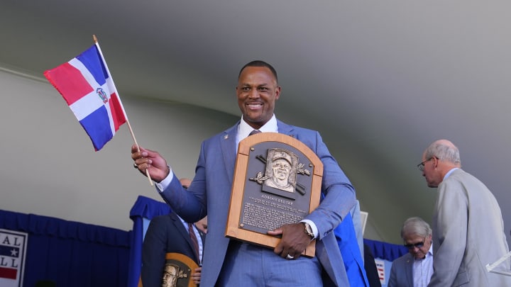 Hall of Fame Inductee Adrian Beltre waves the Dominican Republic flag while holding his Baseball Hall of Fame plaque during the National Baseball Hall of Fame Induction Ceremony in Cooperstown, NY on July 21.