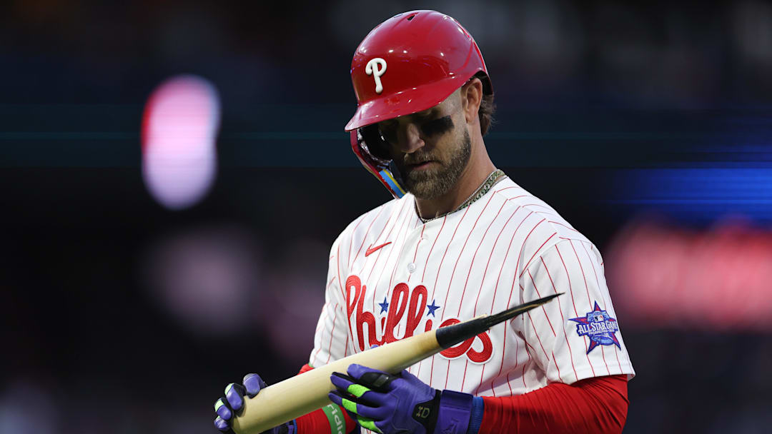 Apr 18, 2026; Philadelphia, Pennsylvania, USA; Philadelphia Phillies first baseman Bryce Harper (3) looks at his bat after his broken bat ground out against the Atlanta Braves during the first inning at Citizens Bank Park. Mandatory Credit: Bill Streicher-Imagn Images
