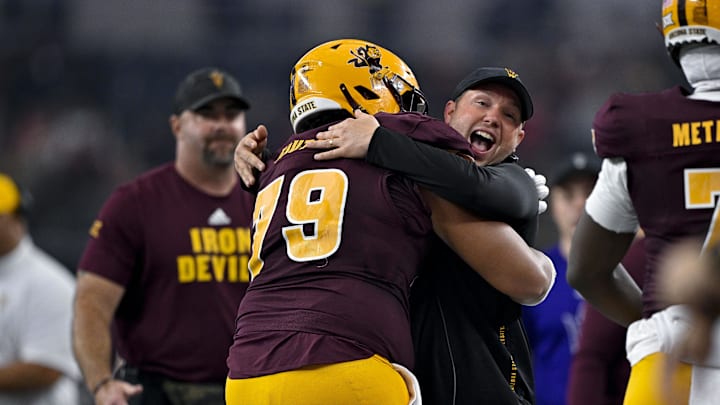 Dillingham celebrates with one of his players during the Big 12 Championship game.