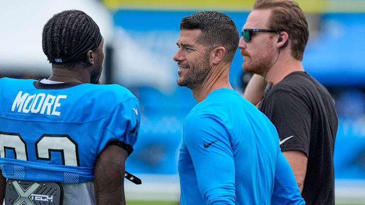 Jul 30, 2024; Charlotte, NC, USA; Carolina Panthers head coach Dave Canales speaks with wide receiver David Moore (83) at Carolina Panthers Practice Fields.