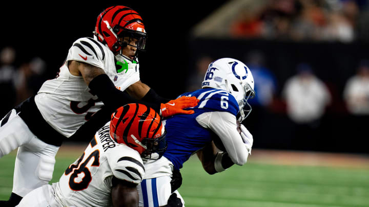 Cincinnati Bengals safety Daijahn Anthony (33) and Cincinnati Bengals linebacker Devin Harper (56) tackles Indianapolis Colts wide receiver Anthony Gould (6) in the second quarter of the NFL preseason game at Paycor Stadium in Cincinnati on Thursday, Aug. 22, 2024.