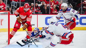 Nov 7, 2025; Detroit, Michigan, USA; Detroit Red Wings right wing Patrick Kane (88) attempts to score a goal as New York Rangers defenseman Braden Schneider (4),  defenseman Carson Soucy (24) and goaltender Jonathan Quick (32) defend the net during the second period at Little Caesars Arena. Mandatory Credit: Tim Fuller-Imagn Images