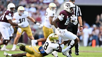 Aug 31, 2024; College Station, Texas, USA; Texas A&M Aggies tight end Tre Watson (84) runs the ball as Notre Dame Fighting Irish safety Adon Shuler (8) defends during the second quarter at Kyle Field. Mandatory Credit: Maria Lysaker-Imagn Images