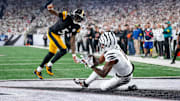 Cincinnati Bengals wide receiver Ja'Marr Chase (1) catches a pass under pressure from Pittsburgh Steelers cornerback Jalen Ramsey (5) for a touchdown in the second quarter of the NFL Week 7 game between the Cincinnati Bengals and the Pittsburgh Steelers at Paycor Stadium in downtown Cincinnati on Thursday, Oct. 16, 2025.