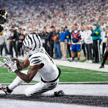 Cincinnati Bengals wide receiver Ja'Marr Chase (1) catches a pass under pressure from Pittsburgh Steelers cornerback Jalen Ramsey (5) for a touchdown in the second quarter of the NFL Week 7 game between the Cincinnati Bengals and the Pittsburgh Steelers at Paycor Stadium in downtown Cincinnati on Thursday, Oct. 16, 2025.