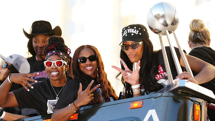Oct 17, 2025; Las Vegas, NV, USA; Las Vegas Aces guard Chelsea Gray (12), guard Jackie Young (0), and center A'Ja Wilson (22) pose for a photo during the 2025 WNBA Championship parade at Toshiba Plaza. Mandatory Credit: Stephen R. Sylvanie-Imagn Images