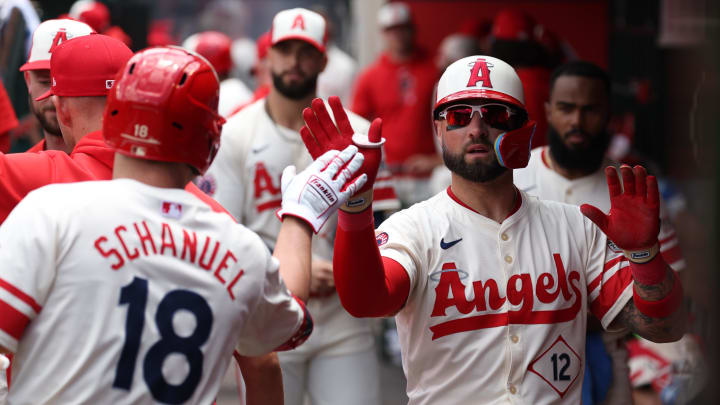 Jun 9, 2024; Anaheim, California, USA;  Los Angeles Angels right fielder Kevin Pillar (12) is greeted by first baseman Nolan Schanuel (18) after scoring a run on a sacrifice fly bySchanuel during the second inning against the Houston Astros at Angel Stadium.