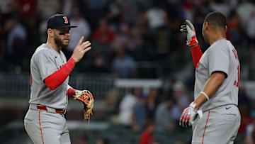 Rafael Devers and Trevor Story celebrate a strong play by the Boston Red Sox infield.