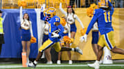 Oct 24, 2024; Pittsburgh, Pennsylvania, USA; Pittsburgh Panthers linebacker Rasheem Biles (31) returns an interception for a touchdown against the Syracuse Orange during the first quarter  at Acrisure Stadium. Mandatory Credit: Barry Reeger-Imagn Images
