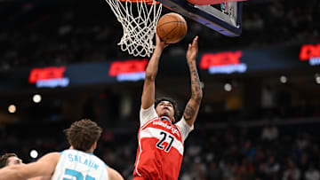Oct 26, 2025; Washington, District of Columbia, USA; Washington Wizards guard Will Riley (27) attempts a jump shot over Charlotte Hornets center Ryan Kalkbrenner (11) and forward Tidjane Salaun (31) during the second quarter at Capital One Arena. Mandatory Credit: Rafael Suanes-Imagn Images