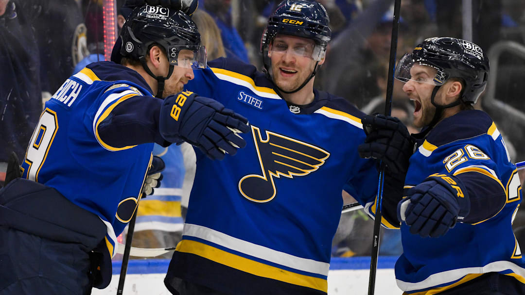 Apr 3, 2025; St. Louis, Missouri, USA;  St. Louis Blues left wing Pavel Buchnevich (89) celebrates with center Radek Faksa (12) and left wing Nathan Walker (26) after scoring against the Pittsburgh Penguins during the second period at Enterprise Center. Mandatory Credit: Jeff Curry-Imagn Images