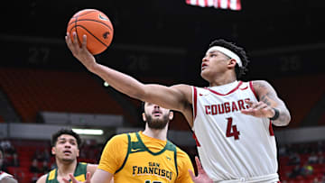 Jan 4, 2025; Pullman, Washington, USA; Washington State Cougars forward LeJuan Watts (4) attempts a basket against San Francisco Dons center Saba Gigiberia (10) in the second half at Friel Court at Beasley Coliseum. Washington State Cougars won 91-82. Mandatory Credit: James Snook-Imagn Images