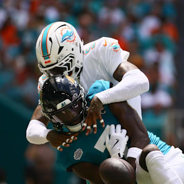 Sep 8, 2024; Miami Gardens, Florida, USA; Miami Dolphins cornerback Jalen Ramsey (5) fouls Jacksonville Jaguars wide receiver Brian Thomas Jr. (7) during the first quarter at Hard Rock Stadium. Mandatory Credit: Sam Navarro-Imagn Images