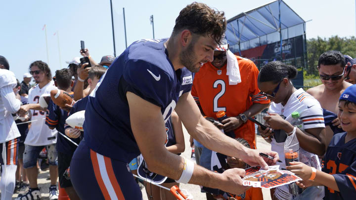 Cole Kmet signs autographs at Halas Hall during training camp. Kmet's role could change away from being a top pass target with all of the weapons available in the passing game.