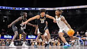 Mar 12, 2025; Kansas City, MO, USA; West Virginia Mountaineers guard Javon Small (7) drives to the basket around Colorado Buffaloes guard Felix Kossaras (15) during the first half at T-Mobile Center. Mandatory Credit: William Purnell-Imagn Images