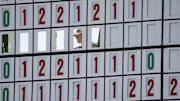 A course worker changes the leaderboard on the 18th hole during the first round of the 2025 Masters tournament. 