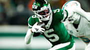 Garrett Wilson runs against the Dolphins with Jalen Ramsey in pursuit.