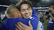 Dodgers pitcher Yoshinobu Yamamoto celebrates with manager Dave Roberts after defeating the Blue Jays in Game 7 of the 2025 MLB World Series.