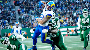Los Angeles Rams tight end Tyler Higbee (89) scores a touchdown in the fourth quarter, despite the defense of New York Jets linebacker Quincy Williams (56), Sunday, December 22, 2024, in East Rutherford.