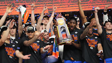 Apr 7, 2025; San Antonio, TX, USA;  Florida Gators players celebrate with the trophy after defeating the Houston Cougars in the national championship game of the Final Four of the 2025 NCAA Tournament at the Alamodome. Mandatory Credit: Robert Deutsch-Imagn Images