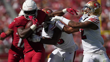 Sep 21, 2025; Santa Clara, California, USA; Arizona Cardinals running back Trey Benson (33) carries the ball as San Francisco 49ers safety Jason Pinnock (25) defends during the second half at Levi's Stadium. Mandatory Credit: Cary Edmondson-Imagn Images