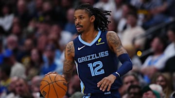 Apr 11, 2025; Denver, Colorado, USA; Memphis Grizzlies guard Ja Morant (12) controls the ball in the second quarter against the Denver Nuggets at Ball Arena. Mandatory Credit: Ron Chenoy-Imagn Images