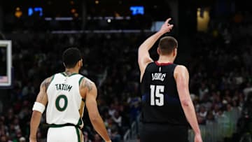 Mar 7, 2024; Denver, Colorado, USA; Boston Celtics forward Jayson Tatum (0) and Denver Nuggets center Nikola Jokic (15) during the first half at Ball Arena. Mandatory Credit: Ron Chenoy-Imagn Images