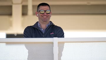 Cincinnati Reds President of Baseball Operations Nick Krall smiles as he takes a phone call during spring training workouts, Friday, Feb. 16, 2024, at the team   s spring training facility in Goodyear, Ariz.