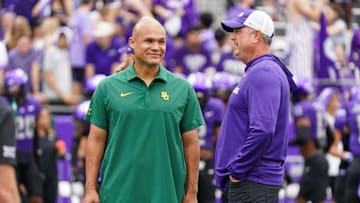 Oct 18, 2025; Fort Worth, Texas, USA; Baylor Bears head coach Dave Aranda and TCU Horned Frogs head coach Sonny Dykes talk on the field prior to a game at Amon G. Carter Stadium. Mandatory Credit: Raymond Carlin III-Imagn Images