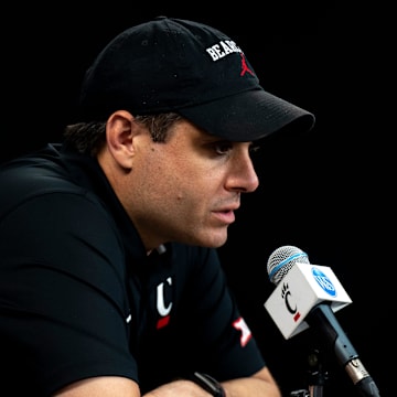 Cincinnati Bearcats head coach Wes Miller speaks at a podium at First Third Arena in Cincinnati on Wednesday, July 16, 2025.