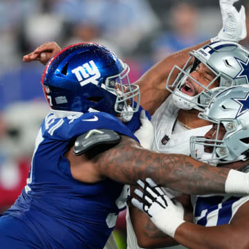 New York Giants defensive tackle Dexter Lawrence II (97) slams into Dallas Cowboys quarterback Dak Prescott (4) after the ball was released, Sunday, September 10, 2023.
