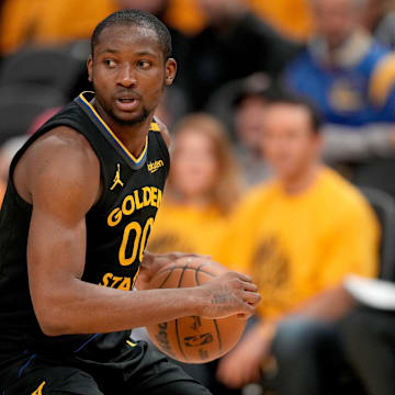 May 12, 2025; San Francisco, California, USA; Golden State Warriors forward Jonathan Kuminga (00) holds onto the ball against the Minnesota Timberwolves in the fourth quarter during game four of the second round for the 2025 NBA Playoffs at Chase Center. Mandatory Credit: Cary Edmondson-Imagn Images